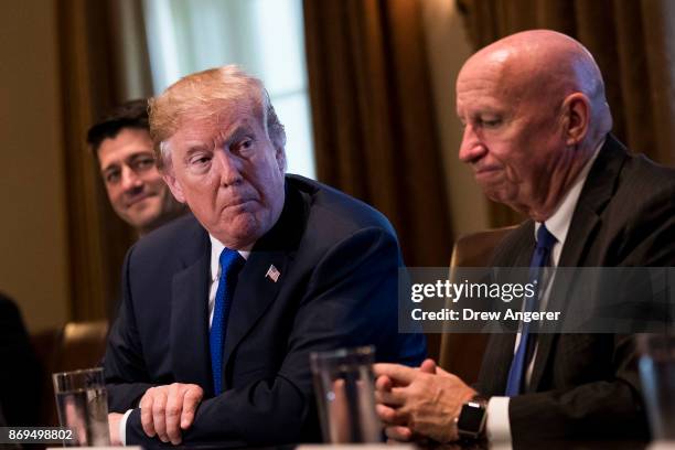 Flanked by Speaker of the House Paul Ryan and House Ways and Means Committee chairman Rep. Kevin Brady , President Donald Trump speaks about tax...