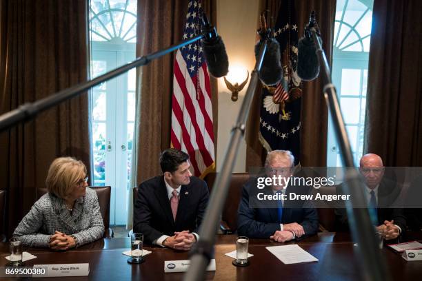 Flanked by Speaker of the House Paul Ryan and House Ways and Means Committee chairman Rep. Kevin Brady , President Donald Trump speaks about tax...