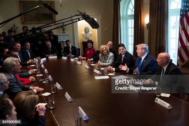 Flanked by Speaker of the House Paul Ryan and House Ways and Means Committee chairman Rep. Kevin Brady , President Donald Trump speaks about tax...