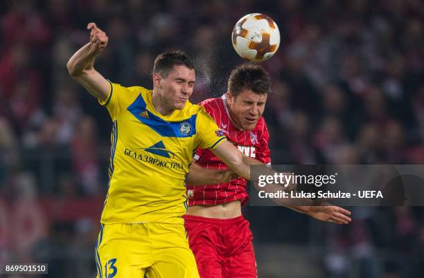 Nikolai Signevich of Borisov and Dominique Heintz of Koeln head the ball during the UEFA Europa League group H match between 1. FC Koeln and BATE...