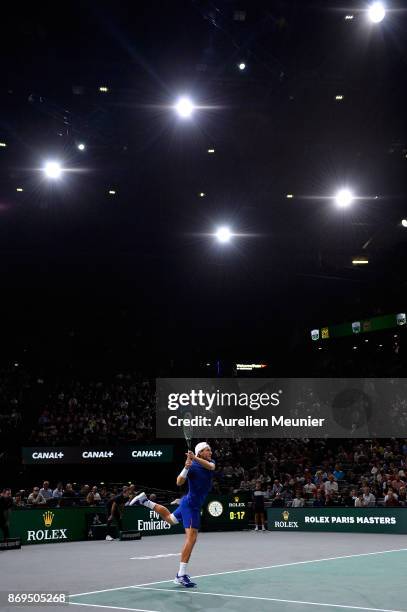 Lucas Pouille of France plays a backhand in the men's single first round match against Jack Sock of the United States of America during day four of...