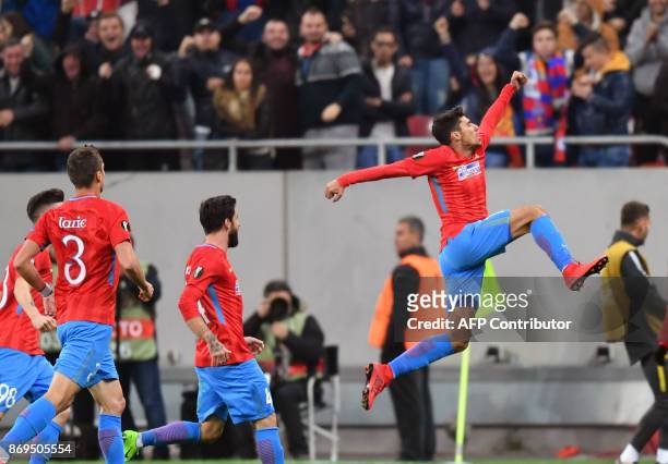 Florinel Steaua Bucharest's Romanian forward Florinel Coman celebrates scoring the opening goal with his teammates during the UEFA Europa League...
