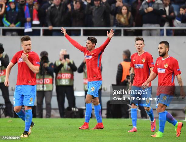 Steaua Bucharest's Romanian forward Florinel Coman celebrates scoring the opening goal with his teammates during the UEFA Europa League group G...