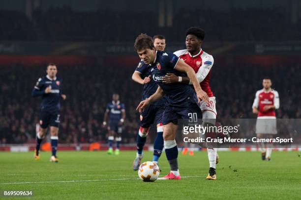Arsenal's Ainsley Maitland-Niles battles for possession with Crvena Zvezda's Filip Stojkovic during the UEFA Europa League group H match between...