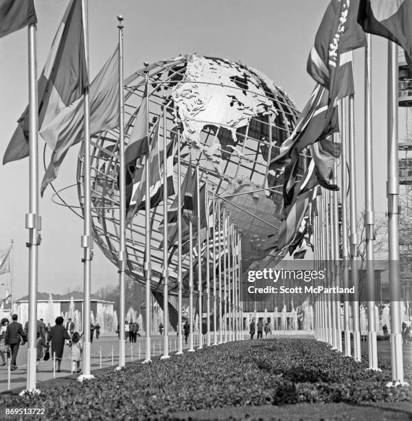 International flags line the main walking path leading to the Unisphere during the 1964-65 World's Fair in Flushing Meadows Corona Park, New York,...