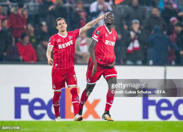 Scorer Sehrou Guirassy of Koeln celebrates his teams third goal with Simon Zoller during the UEFA Europa League group H match between 1. FC Koeln and...
