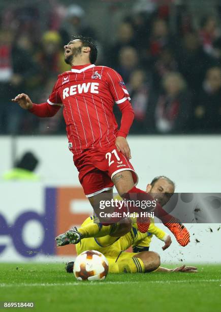 Igor Stasevich of FC Bate Borisov tackles Leonardo Jesus Bittencourt of FC Koeln during the UEFA Europa League group H match between 1. FC Koeln and...