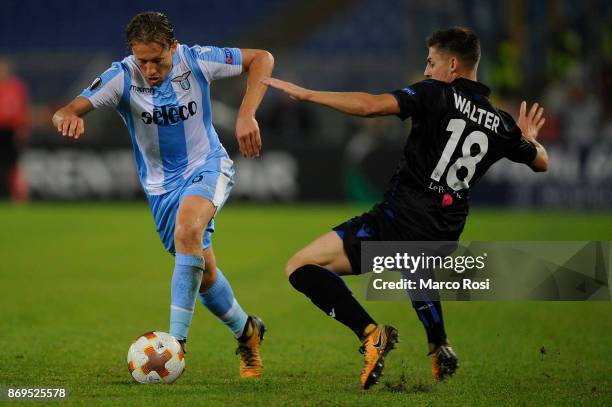 Luiz Senad Lulic of SS Lazio compete for the ball with Remi Walter of OGC Nice during the UEFA Europa League group K match between Lazio Roma and OGC...