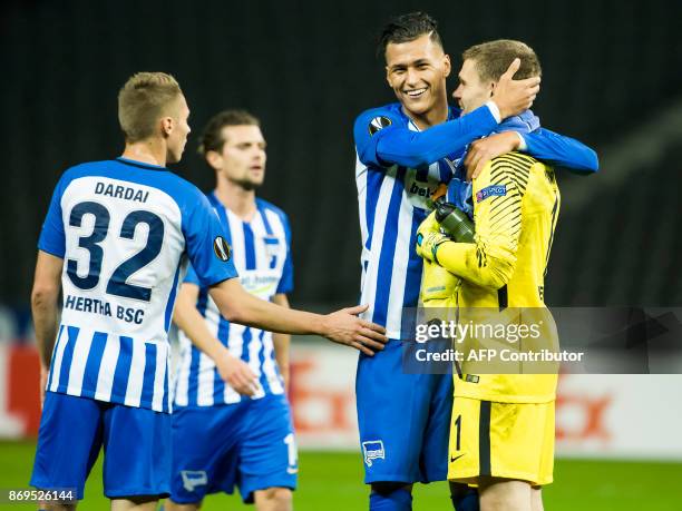 Hertha Berlin's two goals scorer, forward Davie Selke celebrates at the final whistle with teammate goalkeeper Thomas Kraft at the end of the UEFA...