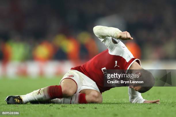 Jack Wilshere of Arsenal reacts to going down injured during the UEFA Europa League group H match between Arsenal FC and Crvena Zvezda at Emirates...