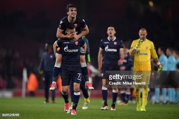 Marko Gobeljic of FK Crvena Zvezda and Filip Stojkovic of FK Crvena Zvezda celebrate after the UEFA Europa League group H match between Arsenal FC...