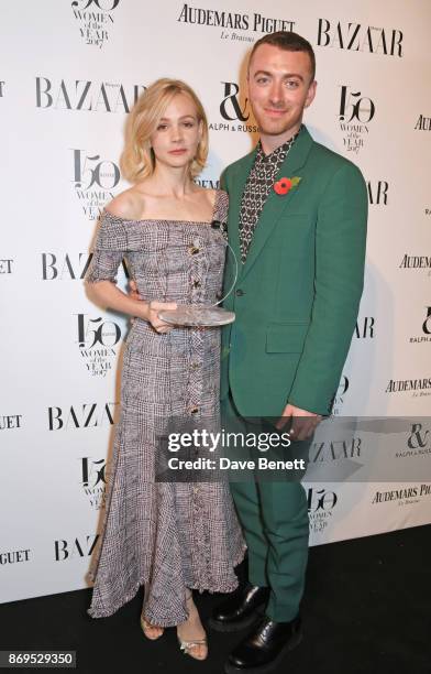 Carey Mulligan, winner of the Philanthropist Award, and Sam Smith attend Harper's Bazaar Women of the Year Awards in association with Ralph & Russo,...