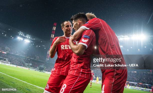Scorer Milos Jojic celebrates his teams fifth goal with Matthias Lehmann and Frederik Soerensen during the UEFA Europa League group H match between...