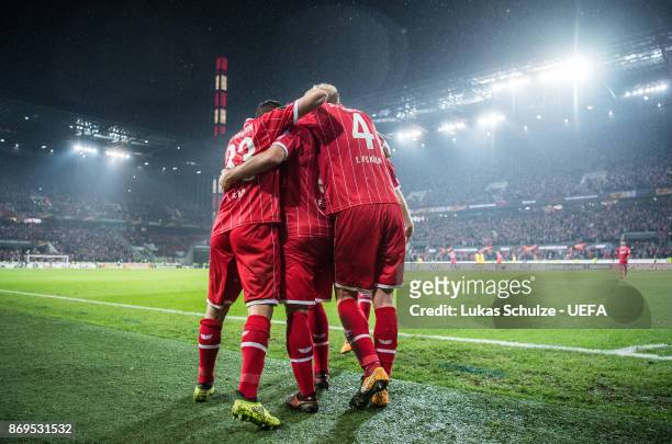 Scorer Milos Jojic celebrates his teams fifth goal with Matthias Lehmann and Frederik Soerensen during the UEFA Europa League group H match between...