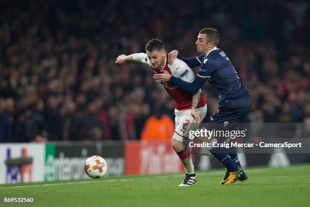 Arsenal's Mathieu Debuchy holds off the challenge from Crvena Zvezda's Nenad Krsticic during the UEFA Europa League group H match between Arsenal FC...