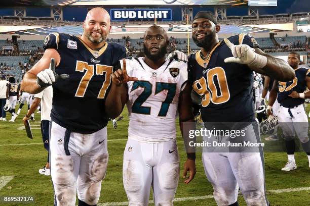 Tackle Andrew Whitworth and Defensive Tackle Michael Brockers of the Los Angeles Rams pose with Running back Leonard Fournette of the Jacksonville...