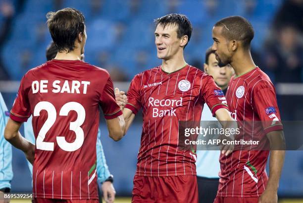 Zulte Waregem's Davy De Fauw , Julien De Sart and Marvin Baudry react after winning the UEFA Europa League Group K football match between Vitesse...