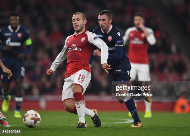 Jack Wilshere of Arsenal takes on Nenad Krsticic of Red Star during the UEFA Europa League group H match between Arsenal FC and Crvena Zvezda at...