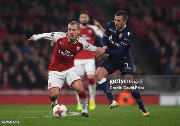 Jack Wilshere of Arsenal takes on Nenad Krsticic of Red Star during the UEFA Europa League group H match between Arsenal FC and Crvena Zvezda at...