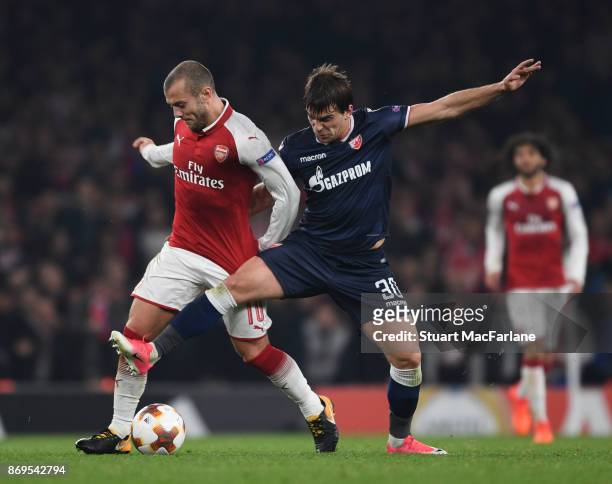 Jack Wilshere of Arsenal takes on Filip Stojkovic of Red Star during the UEFA Europa League group H match between Arsenal FC and Crvena Zvezda at...
