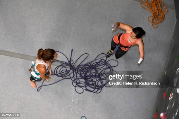 Maureen Beck, right, chats with her climbing partner Sarah Fountain, left, before getting on a climb on the overhanging wall at EVO Rock + Fitness...