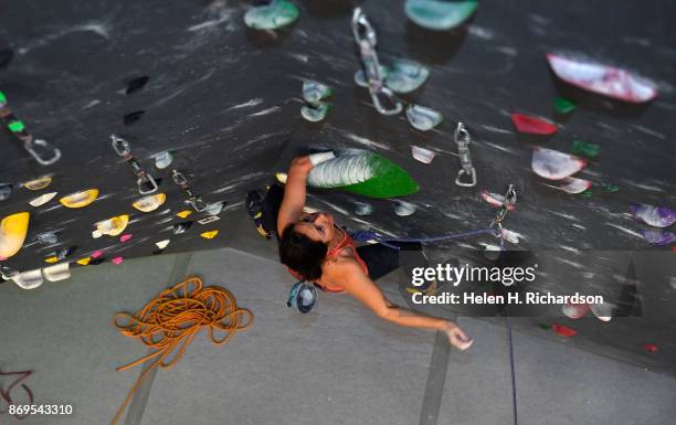 Maureen Beck looks up for her next hand holds as she climbs on the overhanging wall at EVO Rock + Fitness Climbing Gym on October 25, 2017 in...