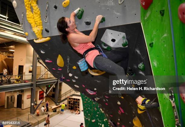 Maureen Beck pulls on a hold to get over a roof on a climb on the overhanging wall at EVO Rock + Fitness Climbing Gym on October 25, 2017 in...