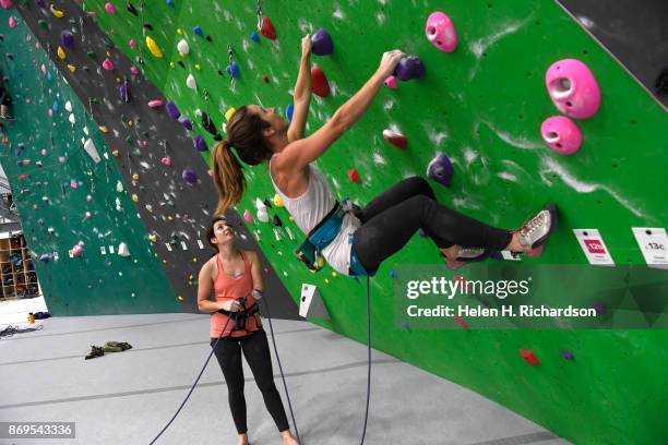 Maureen Beck, left, belays her climbing partner Sarah Fountain, right, as she begins a climb on the overhanging wall at EVO Rock + Fitness Climbing...