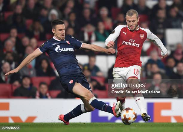 Jack Wilshere of Arsenal challenged by Nenad Krsticic of Red Star during the UEFA Europa League group H match between Arsenal FC and Crvena Zvezda at...