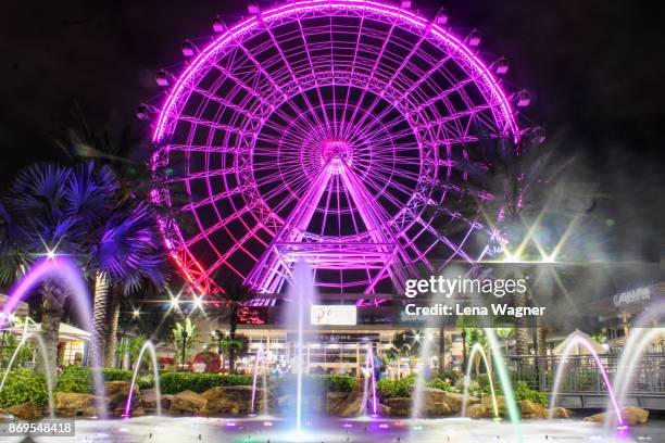 orlando eye ferris wheel at night - orlando florida ferris wheel stock pictures, royalty-free photos & images