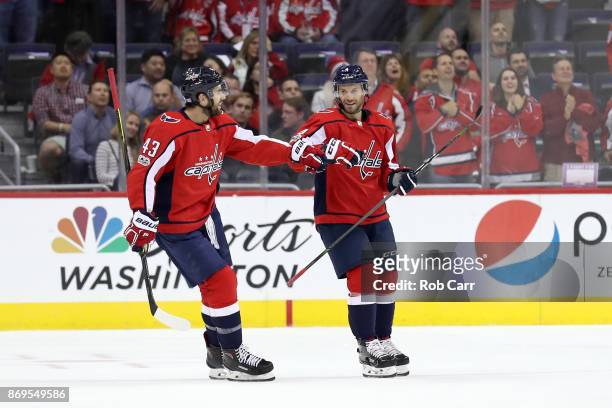 Taylor Chorney of the Washington Capitals celebrates with Tom Wilson after scoring a first period goal against the New York Islanders at Capital One...