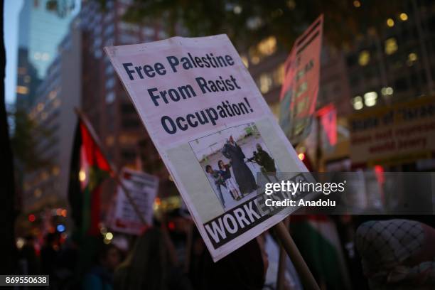 Placard reading "Free Palestine from racist occupation!" is seen during a rally to mark 100th anniversary of Balfour Declaration in support of...