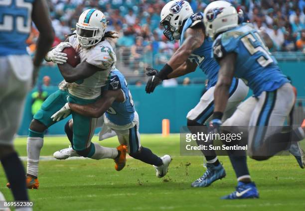 Miami Dolphins running back Jay Ajayi gets a few tough yards against the Tennessee Titans at Hard Rock Stadium in Miami Gardens, Fla., on October 8,...