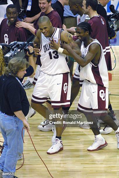 Forward Aaron McGhee and guard Quannas White of the Oklahoma Sooners celebrate against the Xavier Muskateers during the first round of the NCAA...
