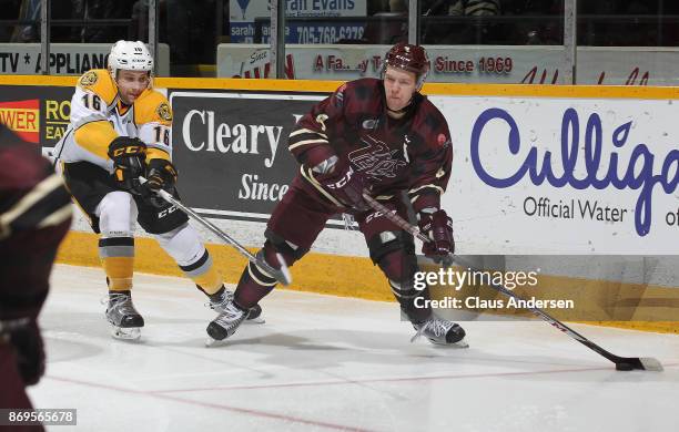 Jordan Ernst of the Sarnia Sting skates to check Matthew Timms of the Peterborough Petes during an OHL game at the Peterborough Memorial Centre on...