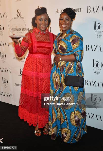 Chimamanda Ngozi Adichie, winner of the Writer of the Year award, and guest attend Harper's Bazaar Women of the Year Awards in association with Ralph...