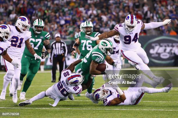 Running back Matt Forte of the New York Jets is tackled by cornerback Shareece Wright of the Buffalo Bills during the first quarter of the game at...