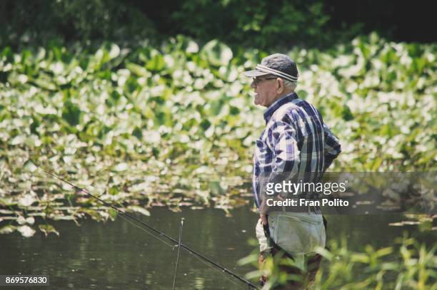 senior man fishing. - baldwin brothers stock pictures, royalty-free photos & images