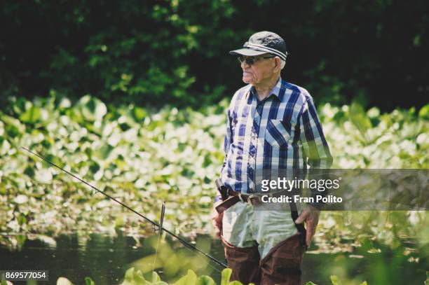 senior man fishing. - baldwin brothers stock pictures, royalty-free photos & images