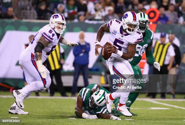 Quarterback Tyrod Taylor of the Buffalo Bills avoids a sack by defensive end Leonard Williams of the New York Jets during the third quarter of the...