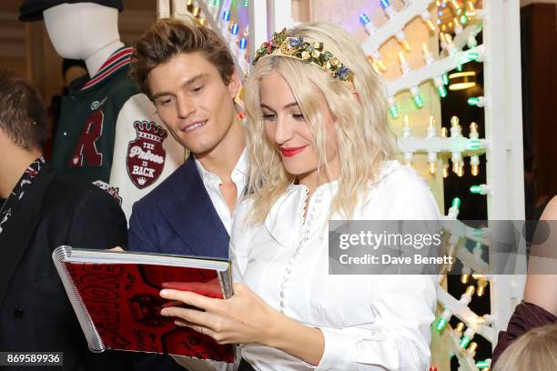 Oliver Cheshire and Pixie Lott attend the Dolce & Gabbana Italian Christmas Millennial Book Signing at Harrods on November 2, 2017 in London, England.