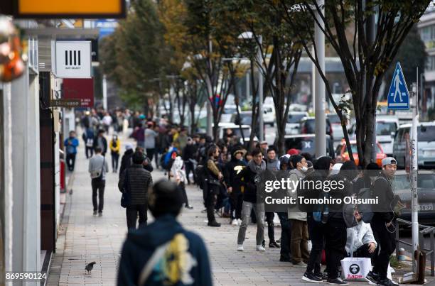 Customers wait in line before the launch of the iPhone X outside the Apple Omotesando store on November 3, 2017 in Tokyo, Japan. Apple launched the...