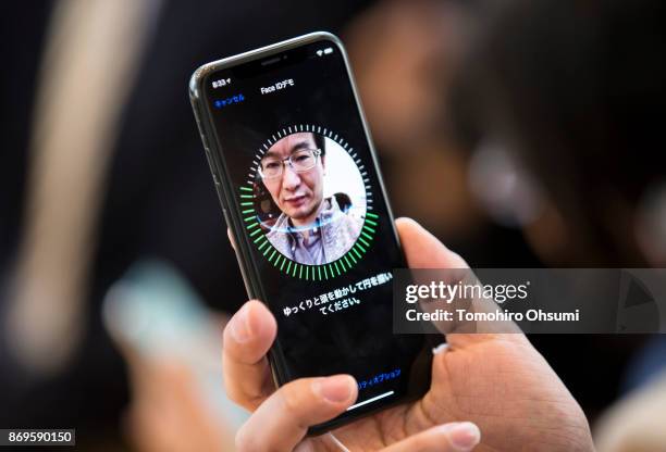 Customer tries Face ID for the iPhone X at the Apple Omotesando store on November 3, 2017 in Tokyo, Japan. Apple launched the latest iPhone featuring...