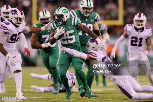 Elijah McGuire of the New York Jets carries the ball as Micah Hyde of the Buffalo Bills defend in the fourth quarter during the fourth quarter of the...