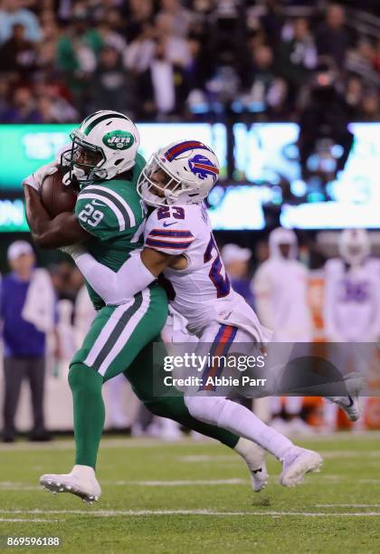 Bilal Powell of the New York Jets carries the ball as Micah Hyde of the Buffalo Bills defends during the third quarter of the game at MetLife Stadium...