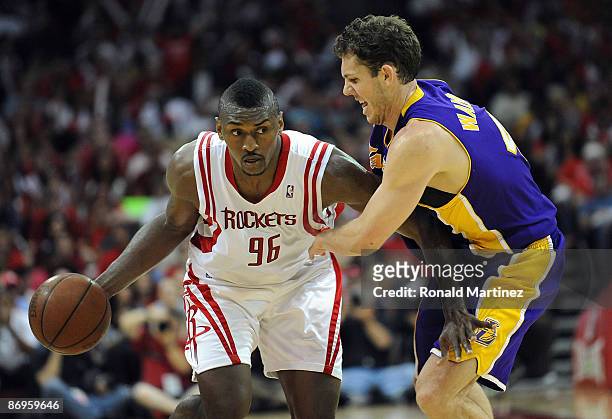 Guard Ron Artest of the Houston Rockets dribbles the ball past Luke Walton of the Los Angeles Lakers in Game Four of the Western Conference...