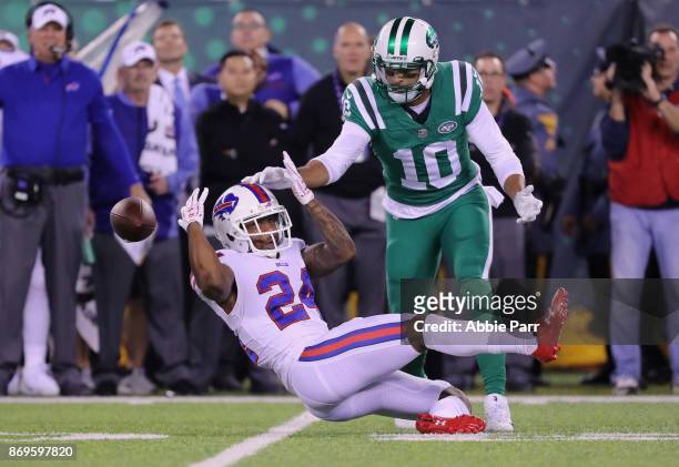 Defensive back Leonard Johnson of the Buffalo Bills breaks up a pass against wide receiver Jermaine Kearse of the New York Jets during the first half...