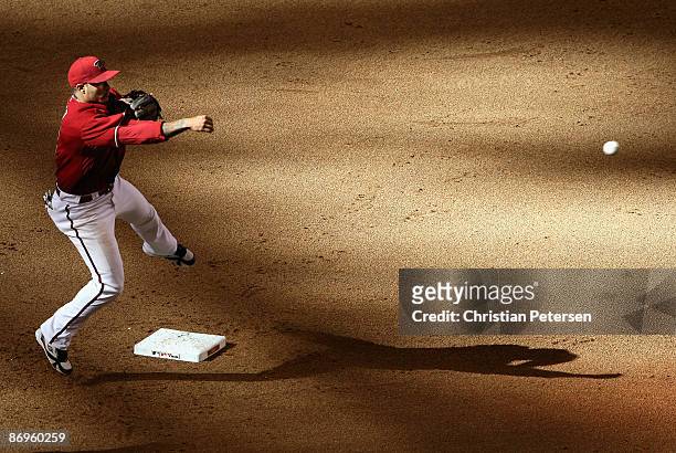 Infielder Felipe Lopez of the Arizona Diamondbacks throws to first base to complete a double play against the Washington Nationals during the eighth...