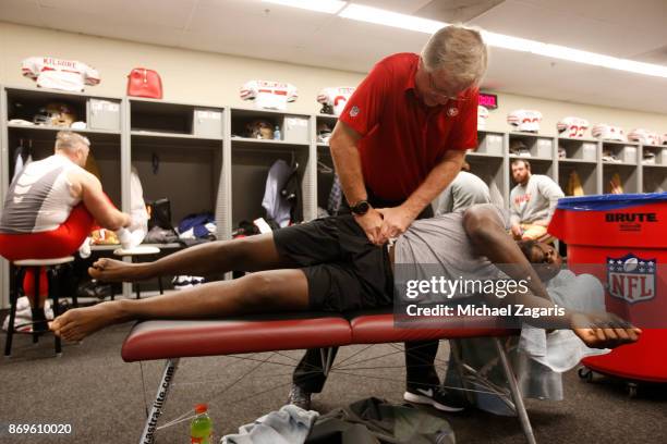 Chiropractor Joe Leahy works on Elvis Dumervil of the San Francisco 49ers in the locker room prior to the game against the Philadelphia Eagles at...