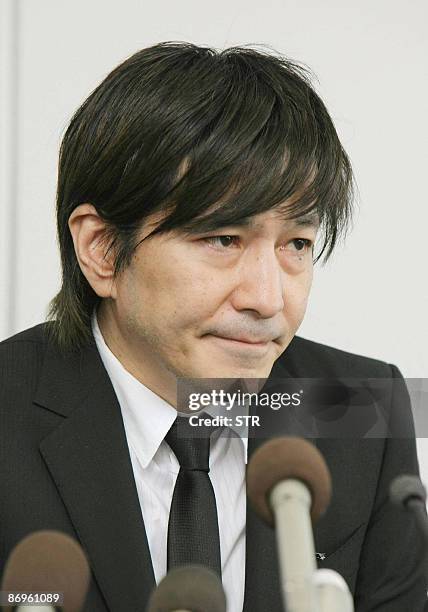 Disgraced Japanese music producer Tetsuya Komuro, one of the most successful in Japan's pop music history who now is accused of fraud, bites his lips...